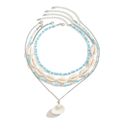 BOHO BEACH Multilayer Puka Shell Necklace with Starfish and Conch Accents